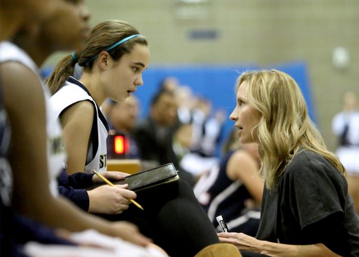 Award winning coach Sonya Elliott talking to a player. Peacelovebasketball blog about the fact that coaches don't know everything.