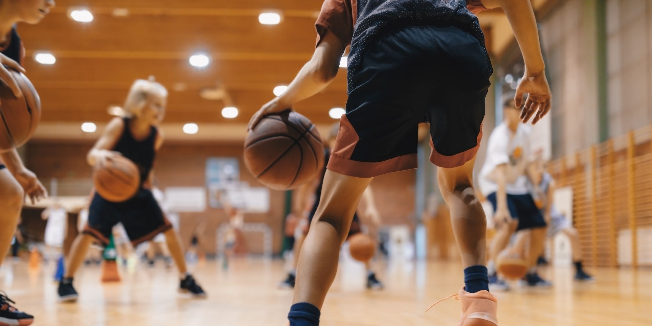 young athlete dribbling basketball