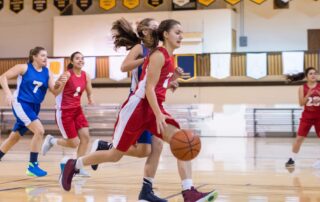 girls running a fastbreak in basketball