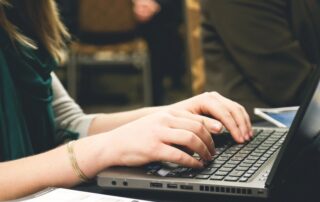 woman typing on a computer